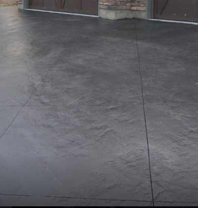 Natural rock textured stamp concrete with a dark gray color 