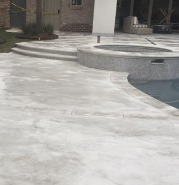 Stamped concrete patio leading into a concrete pool decking in Toledo, Ohio