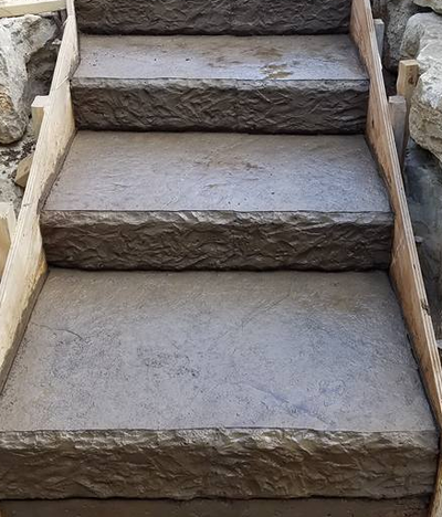Concrete steps with a textured finish on the face of the step 