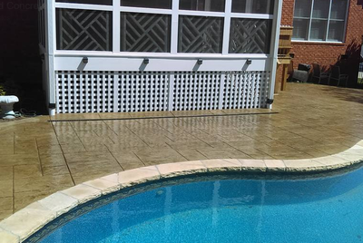 Two toned stained concrete pool decking in Rossford, Ohio