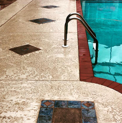 Sealed concrete pool decking with brick paver trim and diamond design in Waterville, Ohio